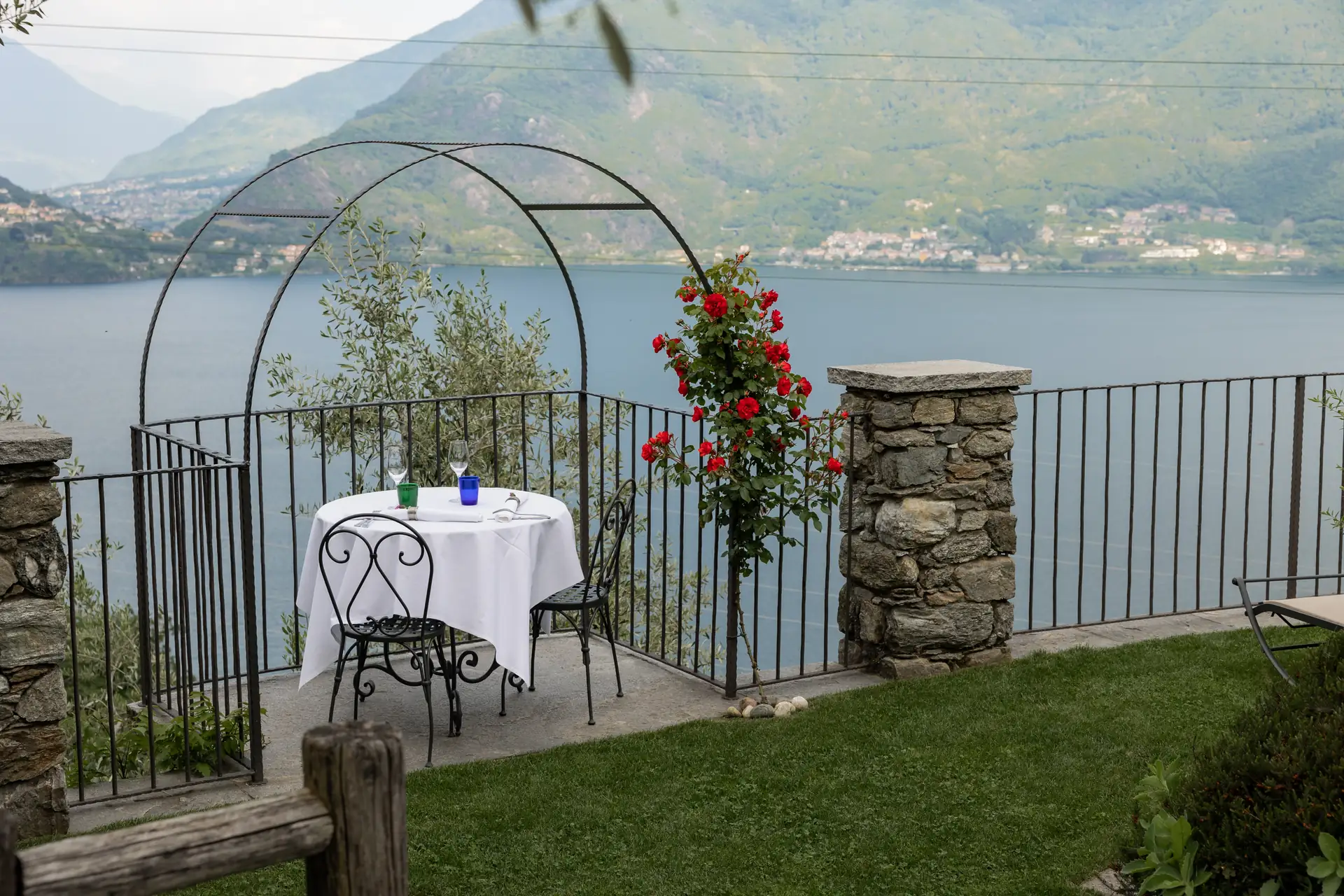 A table set for two on the terrace of Osteria Treterre, overlooking Lake Como